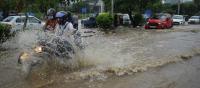 Motorcycle on flooded street. Sudarshan Jha/Shutterstock