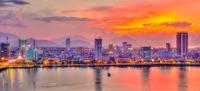 City skyline with mountains at sunset