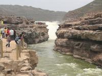 People standing on rocks at Yellow River